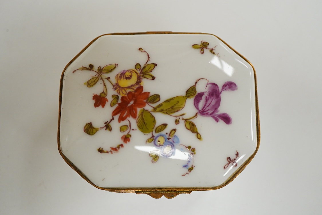 Three early 20th century French porcelain snuff boxes with floral decoration, 7cm wide